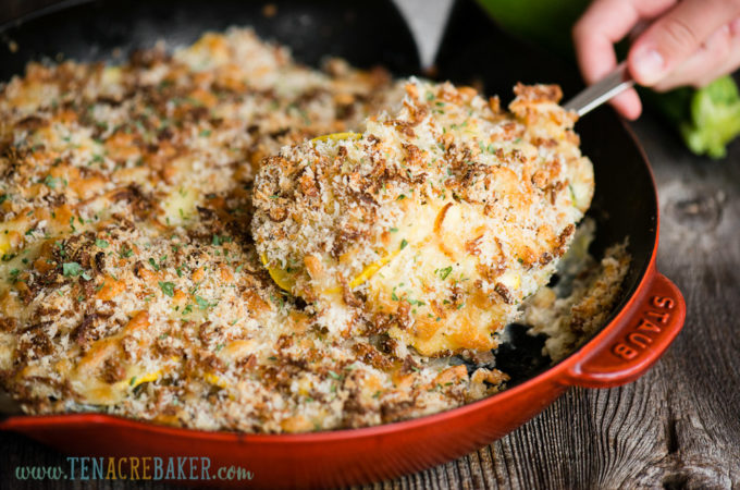 scoop of summer squash casserole in red pan